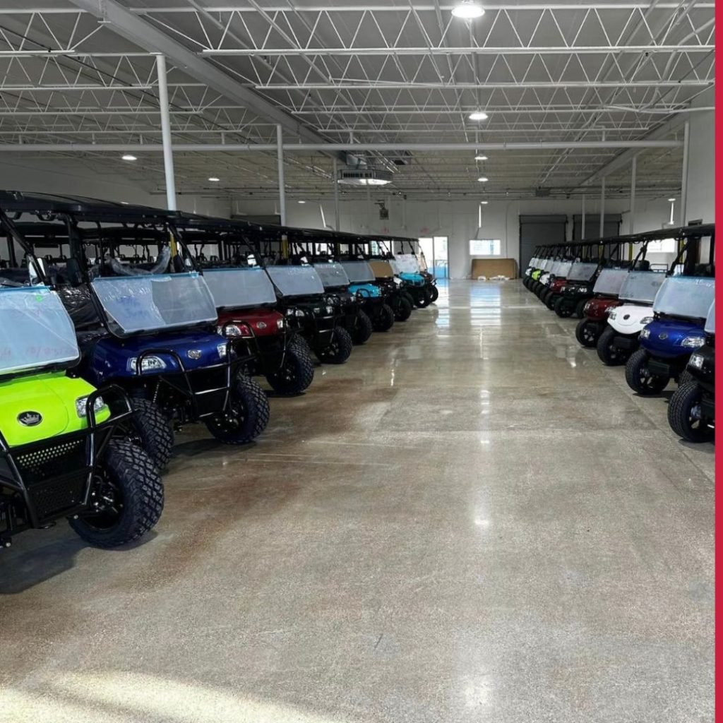 rows of golf carts parked in dealership